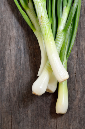 Spring fresh green onion on wooden tableの写真素材
