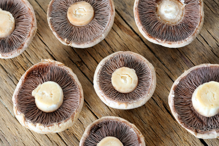 Sliced mushrooms on old wooden tableの写真素材
