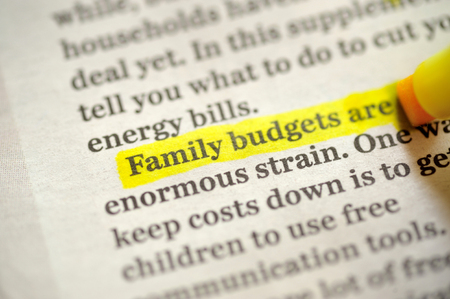 Family budget Using A Highlighter Marker on newspapperの写真素材