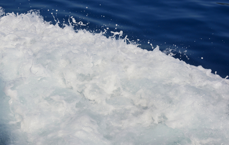Sea waves and foam in Greeceの写真素材