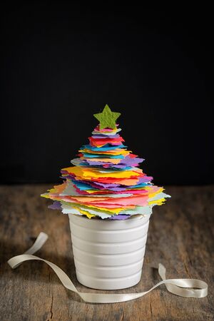 Mini DIY Paper Tree Christmas Decoration on wooden tableの写真素材
