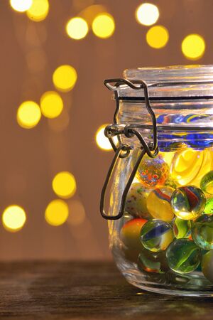 Jar of Marbles and Christmas festive lightsの写真素材