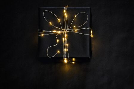 Black Present Box wrapped with string lightsの写真素材