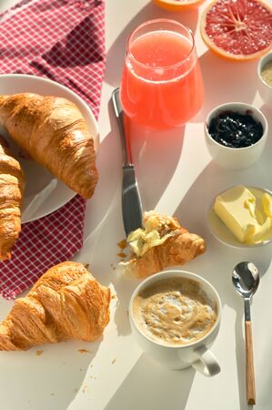 Breakfast With Coffee, Juice And Croissant on White Tableの写真素材