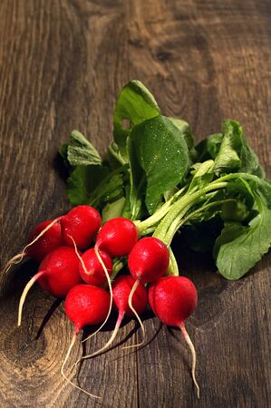 Bunch Of Fresh Radish On Wooden Boardsの写真素材