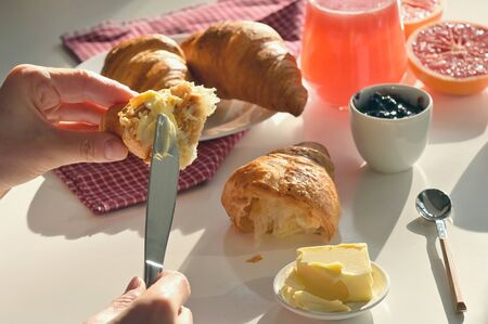 Breakfast With Juice And Croissant on White Tableの写真素材