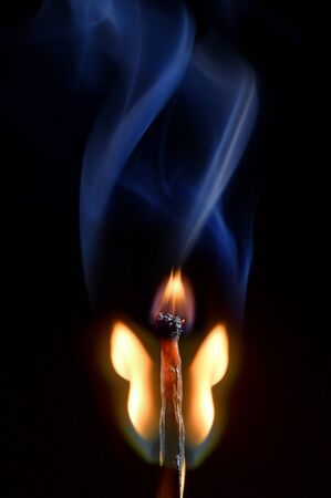 Macro Butterfly Of Burning Matches On Black Backgroundの写真素材