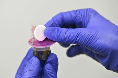 Hands Takes Communion In One Time Use Containers To Protect From The Virusの写真素材