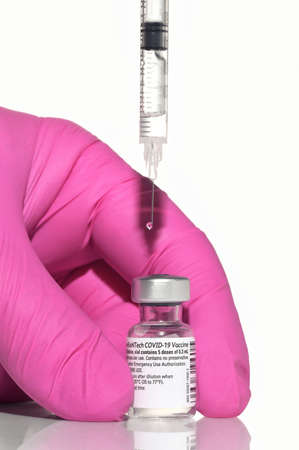 Romania, Galati, 08.02.2021 Pfizer and BioNTech Covid-19 vaccine. Small ampoules with vaccineのeditorial素材