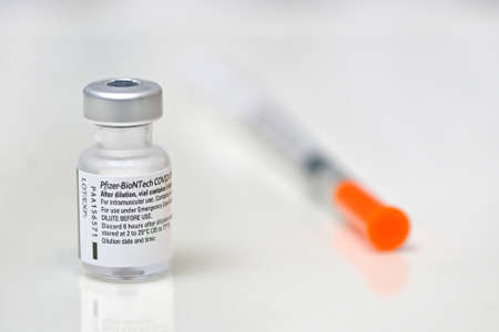 Romania, Galati, 08.02.2021 Pfizer and BioNTech Covid-19 vaccine. Small ampoules with vaccineのeditorial素材