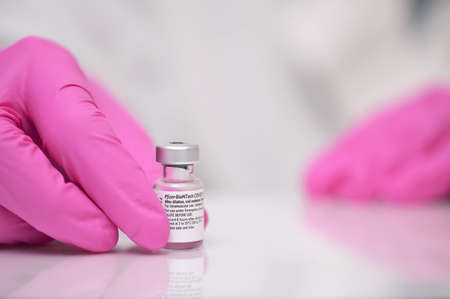Romania, Galati, 08.02.2021 Pfizer and BioNTech Covid-19 vaccine. Small ampoules with vaccineのeditorial素材