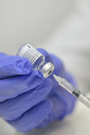 Romania, Galati, 08.02.2021 Pfizer and BioNTech Covid-19 vaccine. Small ampoules with vaccineのeditorial素材