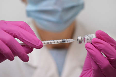 Romania, Galati, 08.02.2021 Pfizer and BioNTech Covid-19 vaccine. Small ampoules with vaccineのeditorial素材