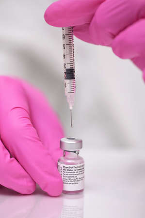Romania, Galati, 08.02.2021 Pfizer and BioNTech Covid-19 vaccine. Small ampoules with vaccineのeditorial素材