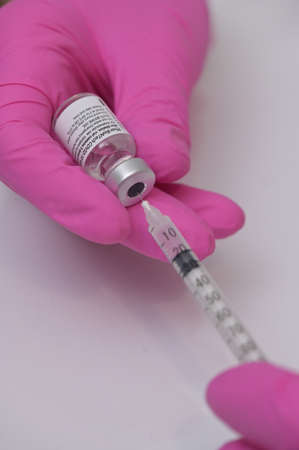 Romania, Galati, 08.02.2021 Pfizer and BioNTech Covid-19 vaccine. Small ampoules with vaccineのeditorial素材