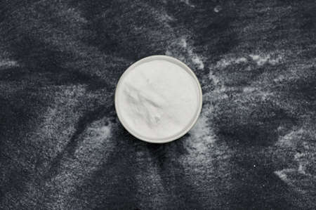 Sodium Bicarbonate Powder On Ardesia Stone Black Backgroundの写真素材