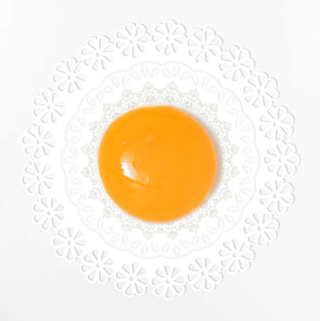 Abstract yellow yolk egg and Vintage lace doilyの写真素材
