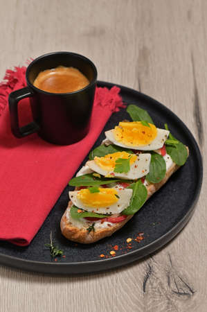 Meal with soft boiled eggs, toast, yogurt and spinachの写真素材