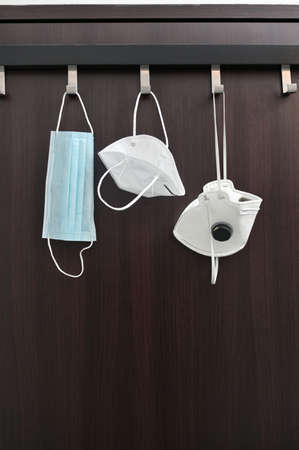 Conceptual Types of Medical Masks Hanging on Hangerの写真素材
