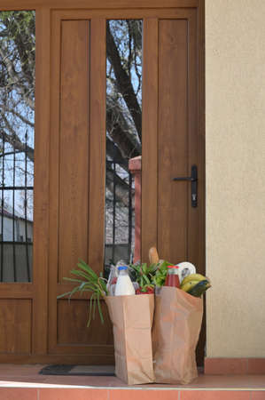 Courier Delivering Food To A Quarantine People At Homeの写真素材