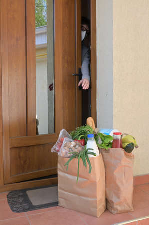 Delivering Food To A Self-isolate Woman or Quarantine At Homeの写真素材