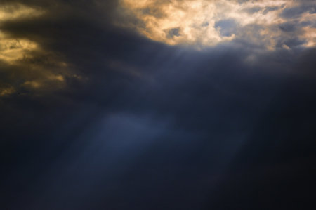 Dramatic sunset with sunrays and clouds in summerの写真素材