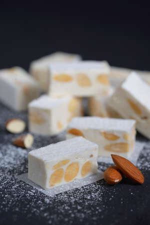 White nougat with almonds on black ardesia plateの写真素材