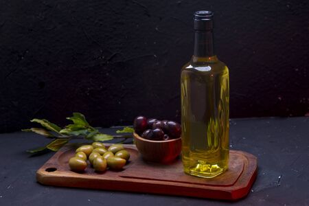 Olive and bowl of olives on the wooden tableの写真素材