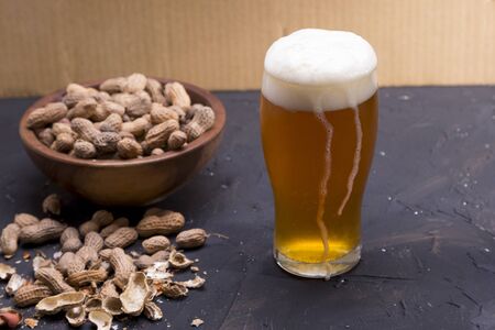 Glass of wheat beer on dark table