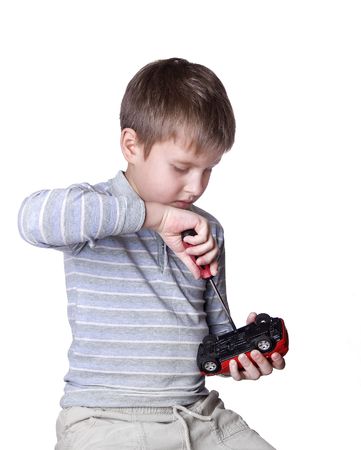 little boy repairs auto over white backgroundの写真素材