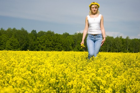 cute young blond woman outdoor in a yellow field wreath on head enjoy in natureの写真素材