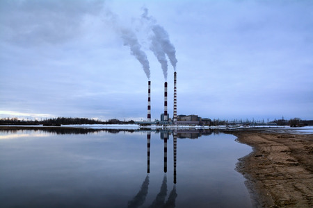 industrial smoke from chimney on blue skyの写真素材
