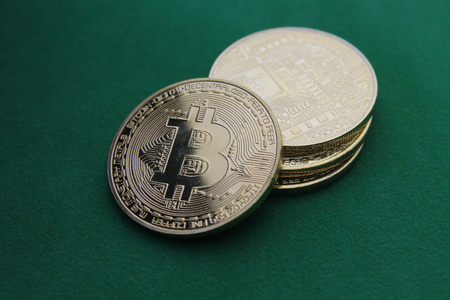 natural gold bitcoin on green background paperの写真素材