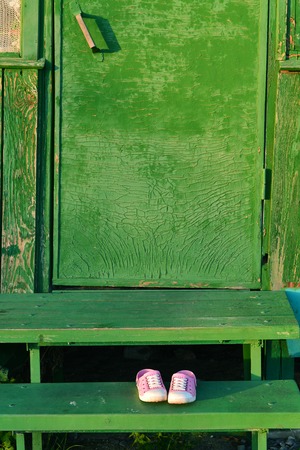 Pair of sandals at the doorstep in country villageの写真素材