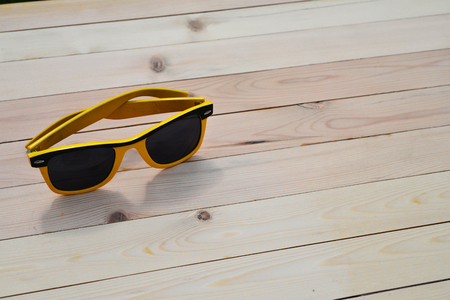 Sunglasses on the table with reflection skyの写真素材