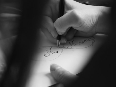 Female hand drawing a tattoo patternの写真素材
