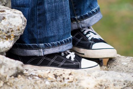 Blue jeans with dark sneakers