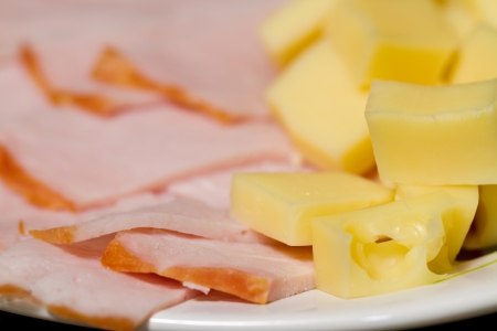 Sliced meat appetizers and cheese in plateの写真素材