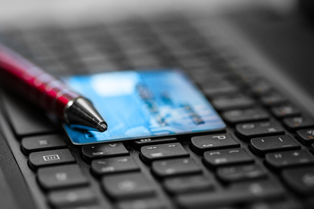 Credit card and pen on keyboard