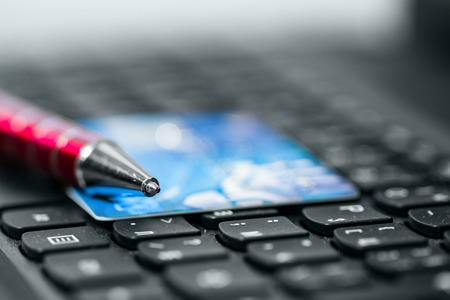 Credit card and pen on keyboardの写真素材