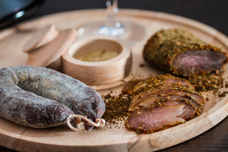 Meat fillet and sausage on cutting wooden plateau Meat fillet and sausage on cutting wooden plateau