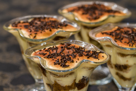 Tiramisu with chocolate in cup. Restaurant gourmet indoor table.の写真素材
