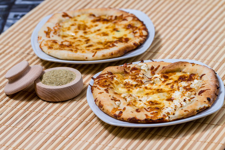 Hot Tasty bread cake with yellow cheese made in fire furnace of bakeryの写真素材