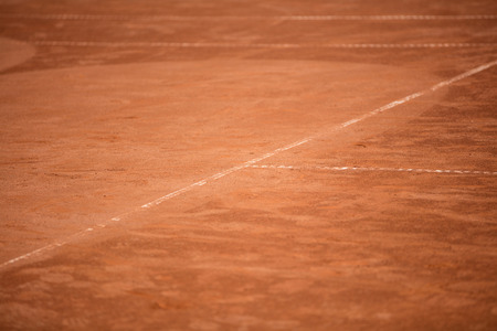 Tennis balls in the shade nets on the ground of clay courtの写真素材