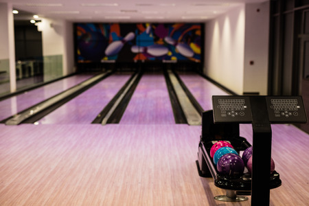 Bowling balls and wooden lane in bowling hallの写真素材