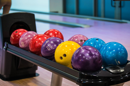 Bowling balls and wooden lane in bowling hall