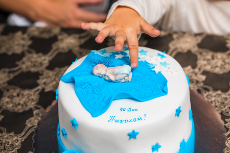 Birthday cake for baby with small sugar baby on itの写真素材