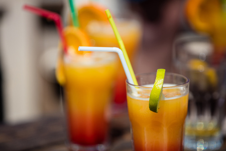Orange cocktail on rustic wooden table.Alcohol orange daiquiri cocktail on beach bar wooden table.の写真素材