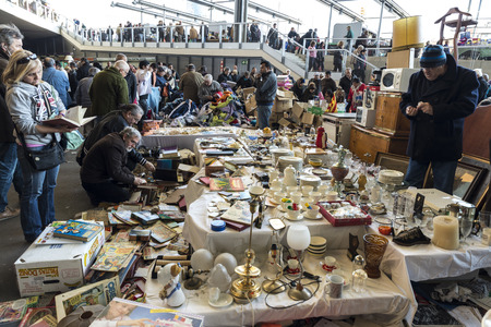 Barcelona, Spain - March 12, 2014  The most famous flea market in Barcelona, also known as Els Encants or Els Encants Vells, located in Glories neighborhood  Customers select goods and seller counting money in second hand antiquities flea market in Barcelのeditorial素材