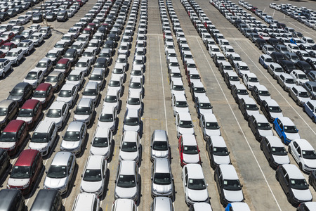 Barcelona, Spain - May 23, 2014  New cars parked in a row in the port of Barcelona  They are waiting to be shipped  New cars parked in a row in the port of Barcelonaのeditorial素材